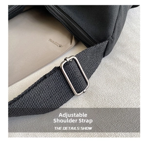 Detail of the adjustable canvas shoulder strap with high-quality silver metal buckle