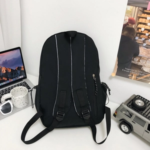 Minimalist black lightweight nylon backpack featuring ergonomic padded shoulder straps