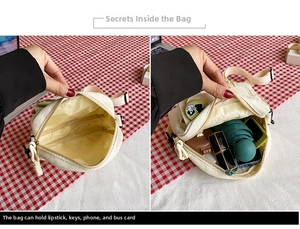 Interior view of the compact canvas crossbody bag showing daily essentials and storage
