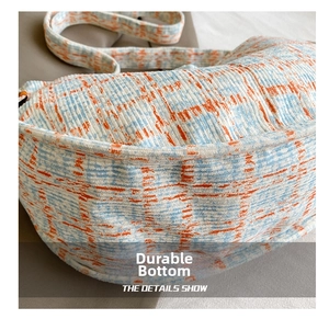 Close-up of the durable wear-resistant base featuring blue and orange tweed texture