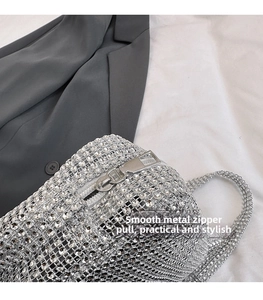 Detail of silver rhinestone handbag with premium sparkling crystal and metal zipper