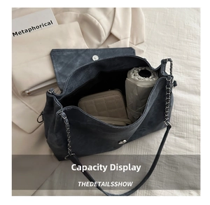 Detail shot of the large interior capacity with metal magnetic closure and chain strap