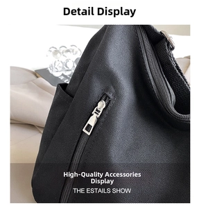 Detailed close-up of premium metal zipper and thick canvas texture on a black tote bag