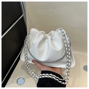 Detail of white pleated cloud bag with silver metal and leather braided chain strap