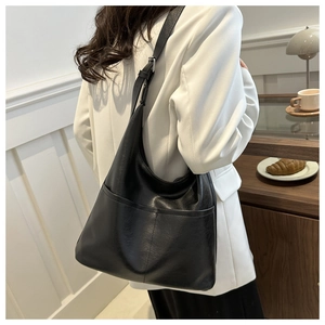 Detail of black large Hobo tote bag with contrast stitching and adjustable leather strap