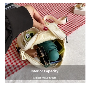 Internal capacity of canvas crossbody bag showing space for phone and cosmetics