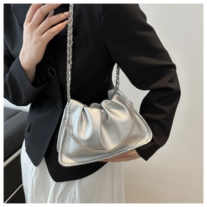 Detail of silver metallic pleated cloud bag featuring decorative thick chain and fine strap