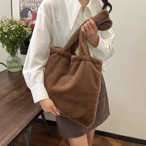 Detail of a brown plush tote bag showing soft texture and spacious autumn fashion design