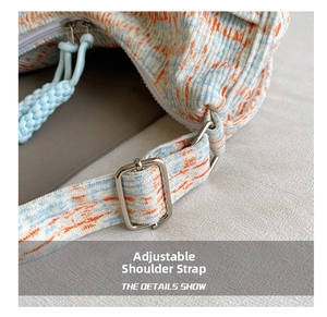 Detail of adjustable shoulder strap with silver buckle on floral corduroy crossbody bag