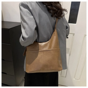 Brown retro PU leather tote bag with wide strap styled with grey office blazer