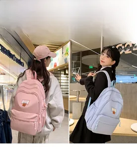 Detail view of pink and blue minimalist backpacks with smiling face fashion patches