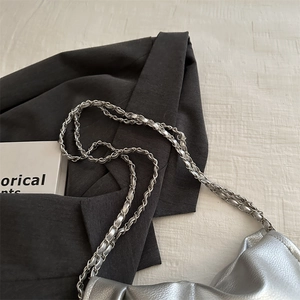 Silver metallic pleated handbag with woven chain strap and minimalist luxury textured leather