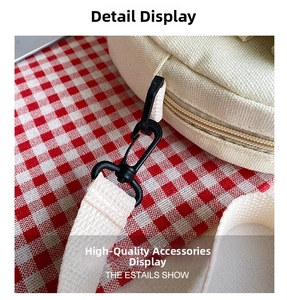 Detail shot of black swivel hook and durable woven strap on minimalist white canvas bag