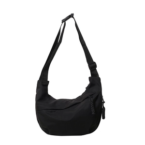 Minimalist black nylon crescent crossbody bag with adjustable wide fabric strap