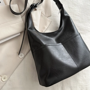 Minimalist black PU leather tote bag with wide shoulder strap for women’s commute
