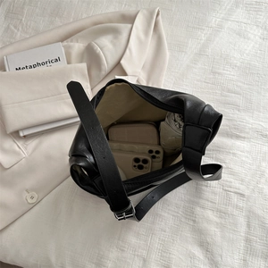 Minimalist black matte leather tote bag with spacious interior and adjustable strap
