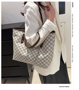 Detailed view of the large capacity retro tote bag with monogram pattern on a model