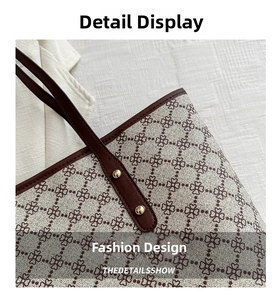 Detail of floral print tote bag featuring brown leather trim and gold rivet hardware