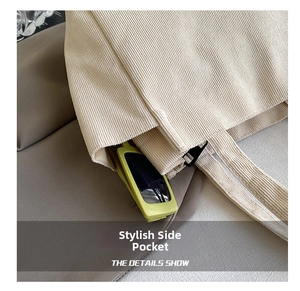 Detail showing side pocket of beige corduroy tote bag with green sunglasses inside