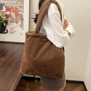 Detail view of large dark brown plush tote bag with soft faux fur texture on shoulder