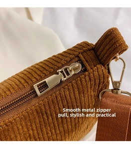 Détail du tissu en velours côtelé marron avec fermeture éclair et crochet en métal