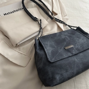 Fashionable dark grey chain tote bag for women shown with professional aesthetic styling