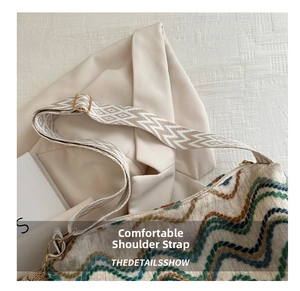 Detail of colorful woven bucket bag featuring vintage wide jacquard shoulder strap
