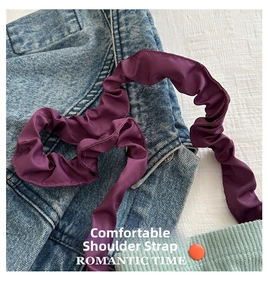 Detail of purple ruched bubble shoulder strap with glossy elastic polyester fabric texture