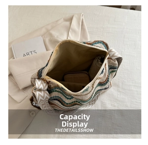 Interior view showing the large capacity of the woven tote bag with daily essentials