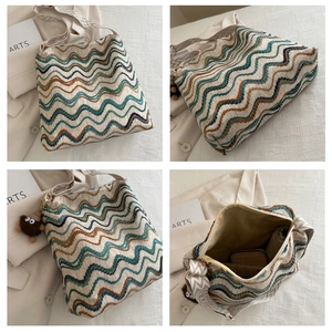 Detailed views of a knitted wave pattern tote bag with wide strap and monster charm