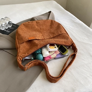Large caramel corduroy crescent bag showing spacious interior with daily essentials