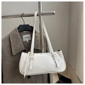 Close-up of white PU leather baguette bag with adjustable light gold metal buckle