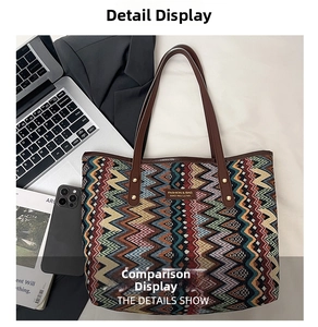 Ethnic woven tote bag with wave patterns and leather handles in a chic office setting