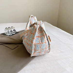 Blue and orange checkered corduroy dumpling crossbody bag with orange fashion label