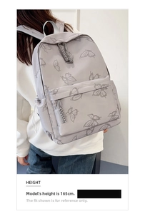 Detail view of butterfly print backpack on model, showcasing lightweight casual design