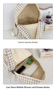 Detail of plaid backpack interior showing spacious multi-pocket storage for laptops and books