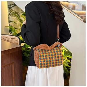 Detail of colorful houndstooth tweed crossbody bag with plush brown trim and strap