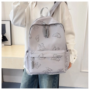 Close-up of butterfly print backpack with long woven zip puller and front pocket