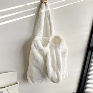 Close-up of white plush tote bag hanging on wall with stylish window blind shadows