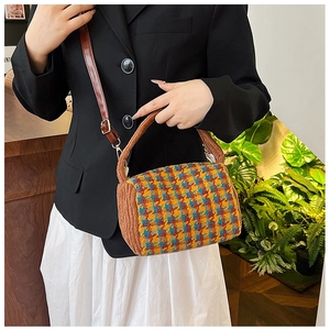Detail of cylinder crossbody bag with houndstooth pattern and plush brown trim