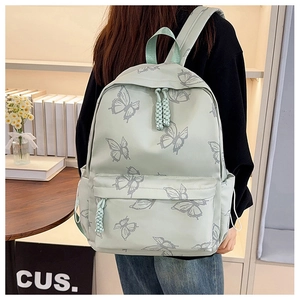 Detail of mint green butterfly print backpack with woven zipper pulls and side pocket