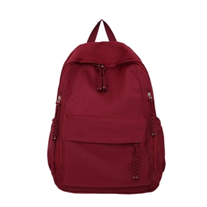 Burgundy nylon backpack with main zipper compartment and woven rope zipper pulls
