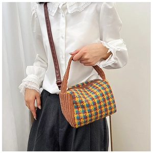 Detail of color-block plaid crossbody bag with corduroy texture and adjustable strap