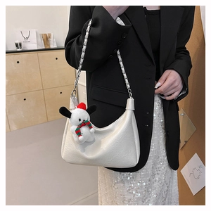 White pleated tote bag with silver chain strap and a cute dog charm accessory
