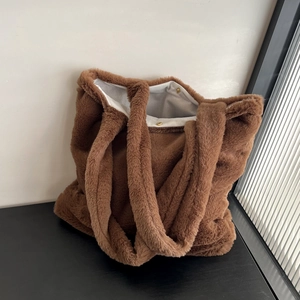 Detail of caramel plush tote bag featuring soft faux fur texture and magnetic closures