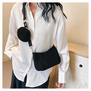 Détail d'un sac bandoulière en velours côtelé noir avec petite pochette ronde