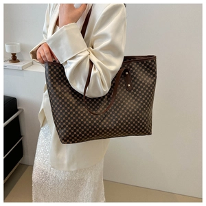 Close-up of geometric dot pattern and rivet details on a large tote bag for women