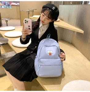 Light purple backpack showing large capacity and fashion label details for students