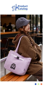 Detail of purple canvas tote bag with black logo and adjustable strap for daily use