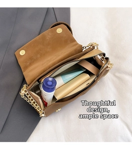 Detail view of the brown faux leather tote interior showing ample storage and gold chain